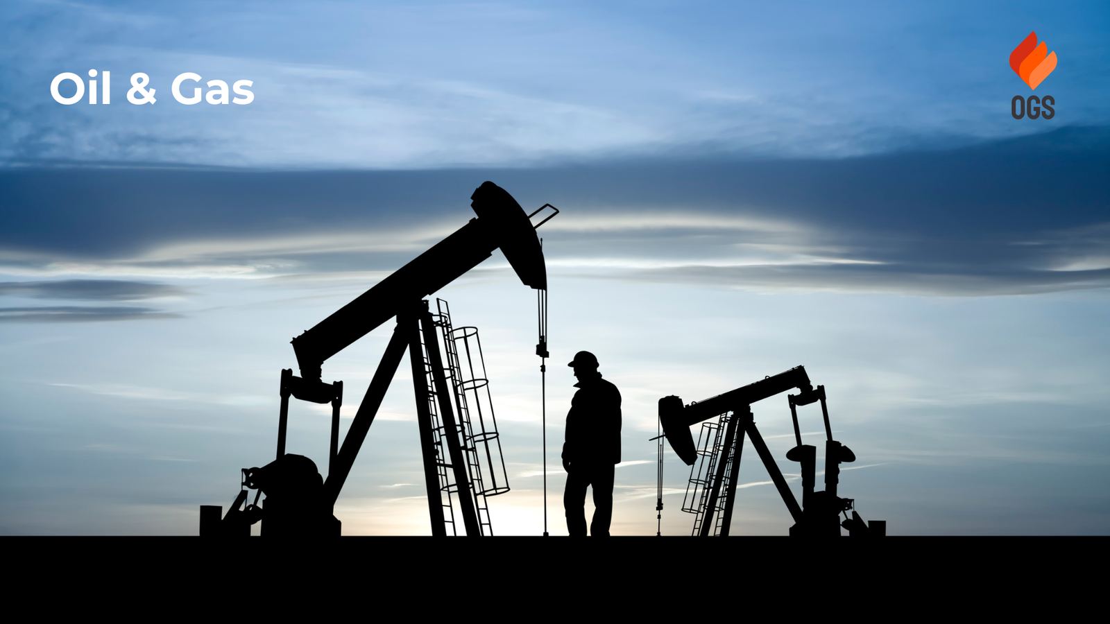 Pumpjacks and a field worker silhouetted at dusk