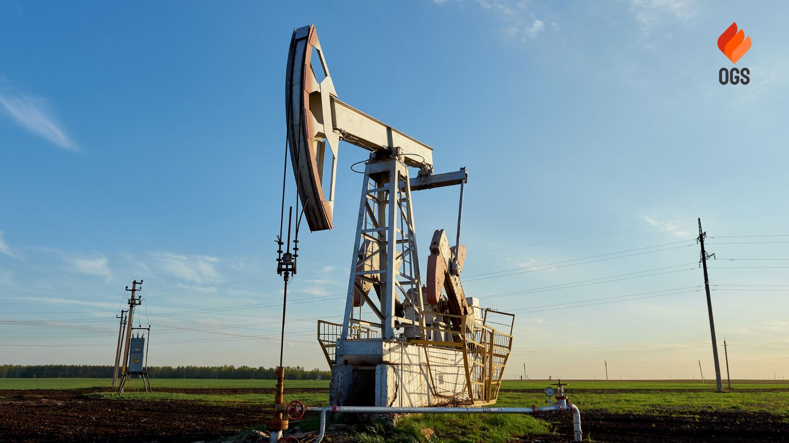 Pumpjack in an open oil field under a clear sky